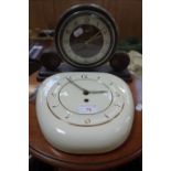 A VINTAGE KITCHEN CLOCK in a glazed cream ceramic case and an Art Deco Metamec mantel clock (2)