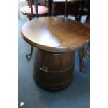 AN OAK 'BARREL' SHAPED TABLE and two iron standard lamps (3)