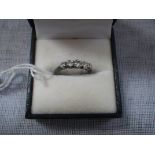 A FIVE STONE DIAMOND DRESS RING on an 18ct yellow gold shank, ring size N