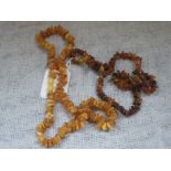 A BUTTERSCOTCH AMBER NECKLACE and one other similar (2)