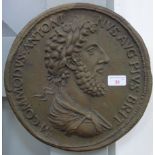A DECORATIVE CAST WALL PLAQUE in the form of an oversized Roman coin