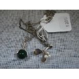 KULTASEPPA SOLOVAARA: A Finnish silver and green stone swivel pendant, attached to a silver chain,