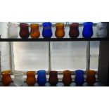 A COLLECTION OF VICTORIAN GLASS GARDEN CANDLE LIGHTS of various colours