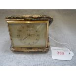 A VINTAGE TRAVEL CLOCK in a snakeskin case