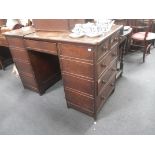 A 19TH CENTURY OAK SHOP OR CLERK'S DESK, with two banks of drawers facing left and right, flanking a
