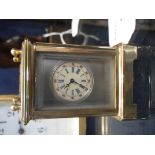 A MINIATURE BRASS CASED CARRIAGE CLOCK with inset porcelain panels, 6cm high