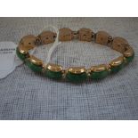 A "JADEITE" BRACELET, set in 14k yellow gold with concealed clasp