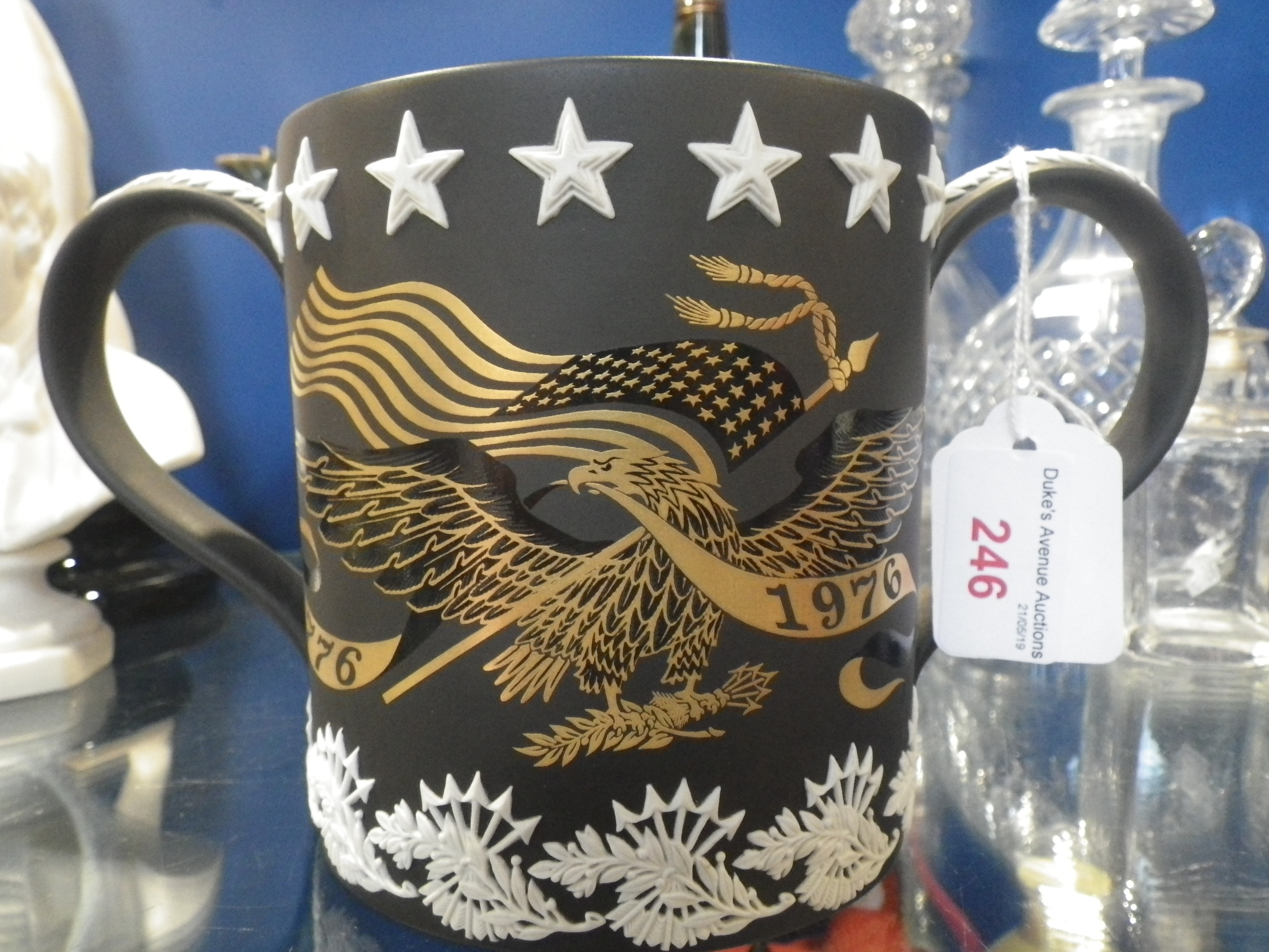 A WEDGWOOD BROWN BASALT TWO HANDLED MUG, celebrating the American Bicentennial 1976, by Richard