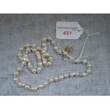 A CULTURED PEARL NECKLACE with a gold clasp