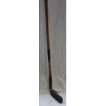 A VINTAGE HICKORY SHAFTED GOLF CLUB, stamped 'J. HERRICT MAKER GLASGOW' 86.5cm long (overall)