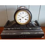 A 19TH CENTURY BLACK SLATE MANTEL CLOCK of barrel form with broad scrolling base, the French