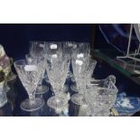 SIX CUT GLASS WINE GLASSES, four similar and a cut glass jug