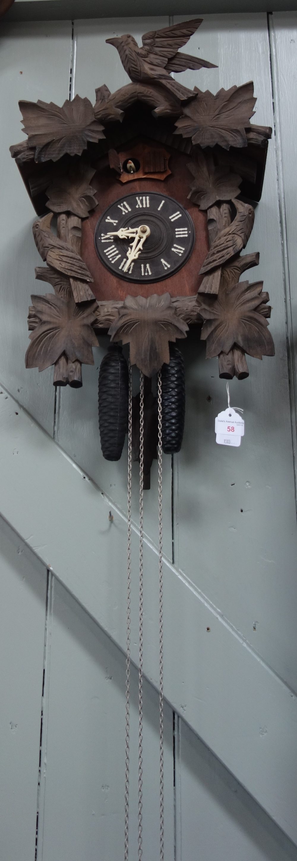 A 20TH CENTURY BLACK FOREST THREE TRAIN CUCKOO AND QUAIL CLOCK (back door and gong missing)