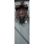 A 20TH CENTURY BLACK FOREST THREE TRAIN CUCKOO AND QUAIL CLOCK (back door and gong missing)