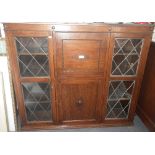 A 1920S OAK DISPLAY CABINET with central bureau, 127cm wide