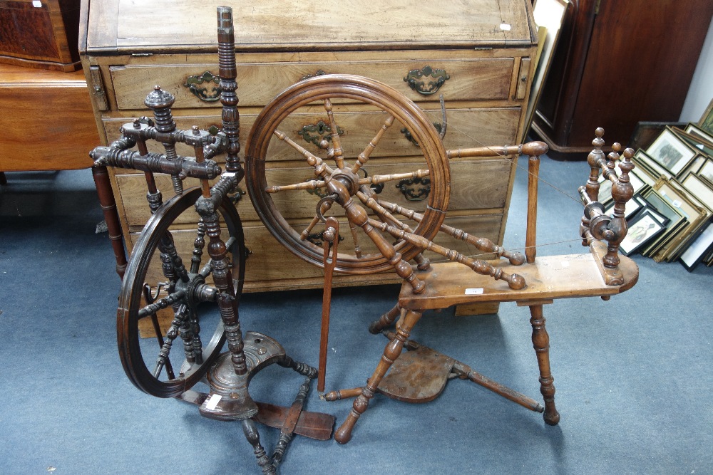 AN ANTIQUE FRUITWOOD SPINNING WHEEL, 90cm wide and a similar upright spinning wheel (2)