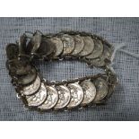 A WHITE METAL COIN BRACELET