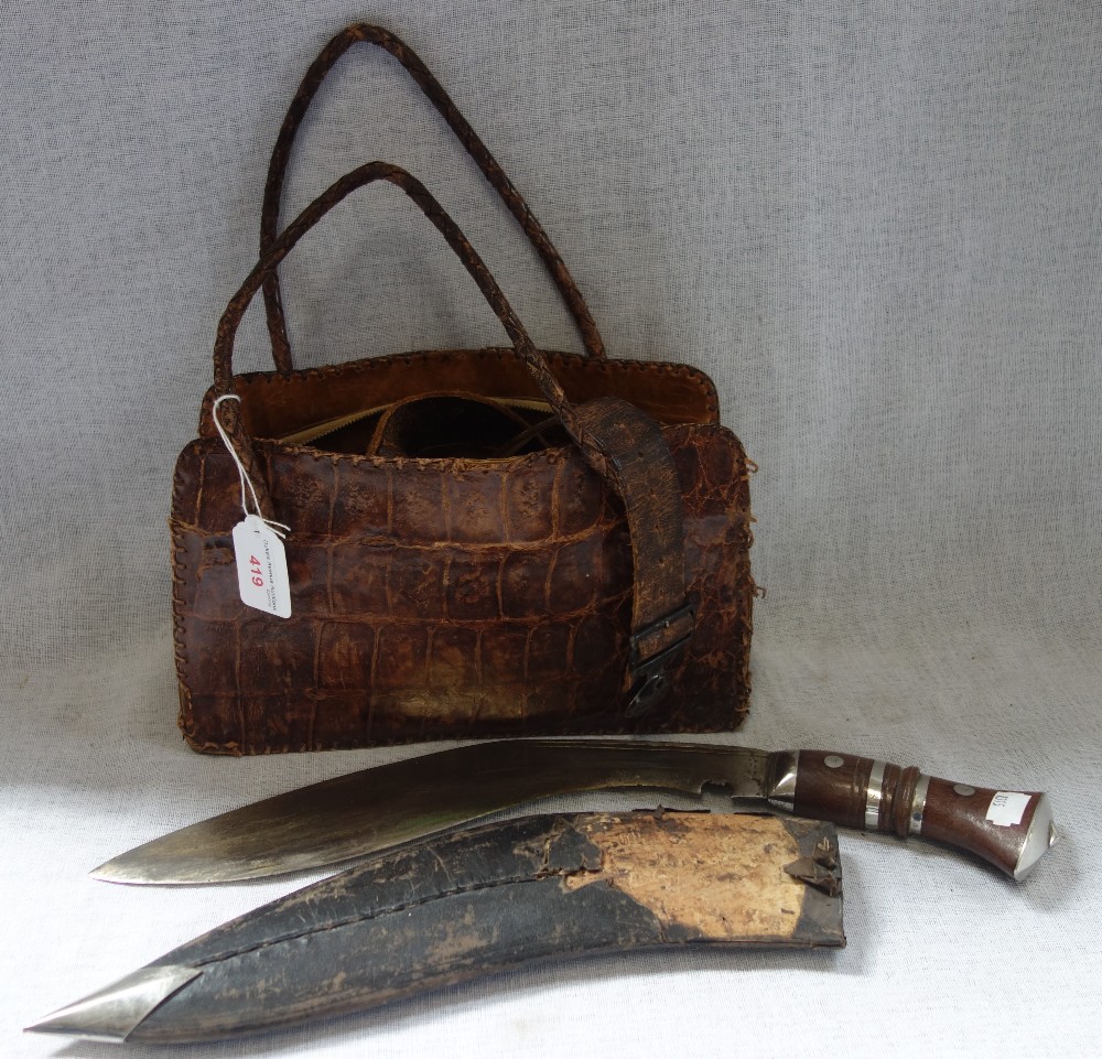 A CROCODILE HANDBAG, A KUKRI, AND A BOY SCOUTS BELT; BE PREPARED