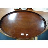 A MAHOGANY OVAL TRAY with brass handles, 75cm wide