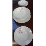 A FRENCH PART CREAM POTTERY DINNER SERVICE with transfer printed monogram 'R B', comprising footed