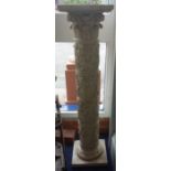 A RECONSTITUTED STONE STAND in the form of a carved classical column, 97cm high