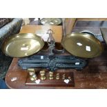 A SET OF 19TH CENTURY CAST IRON BALANCE SCALES with brass pans embossed 'B D', with a set of six