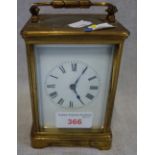 A FRENCH BRASS CASED STRIKING CARRIAGE CLOCK, the white enamel dial with Roman numerals, the eight