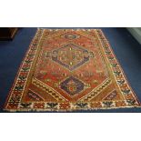 A RED GROUND AFGHAN RUG, 143cm x 200cm