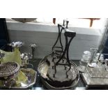 A SILVER PLATED ROCOCCO STYLE TANTALUS STAND (no bottles) and three silver plated trays