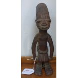 AN AFRICAN CARVED WOOD FIGURE WEARING BEADS, 25cm high