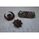 A GARNET CRESCENT BROOCH, one other and a French paste brooch (3)