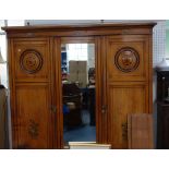 A VICTORIAN PINE TRIPLE WARDROBE, with ebonised and painted decoration and central mirror door,