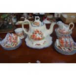 A 19TH CENTURY STAFFORDSHIRE TEA SERVICE decorated with pink transfer chinoiserie scenes and blue