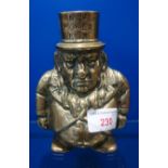 A BRASS MONEY BOX in the form of 'Paul Kruger' with 'Transvaal Money Box' on his top hat, 14cm high