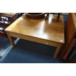 AN ERCOL COFFEE TABLE of square form, with an elm top, 69cm wide