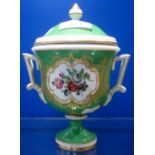 A 19TH CENTURY GREEN GLAZED URN and cover, decorated with a botanical spray, 18cm high