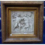 A RECONSTITUTED MARBLE PLAQUE DEPICTING THREE CHERUBS, 'Les Enfants Triomphant' within a gilt frame,