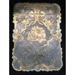 A VICTORIAN SILVER-GILT CARD CASE, chased and engraved with scrolls and floral bouquets, 10cm