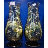 A PAIR OF VICTORIAN GREEN GLASS VASES with enamelled floral and foliage decoration, 32.5cm high
