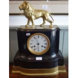 A 19TH CENTURY SLATE CASED MANTEL CLOCK decorated with a gilt spelter lion, 48cm high