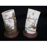 A PAIR OF ORIENTAL IVORY BRUSH POTS with overlaid gilt lacquered coastal scenes, on wooden bases,