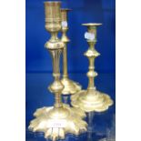 AN 18TH CENTURY BRASS PETAL CANDLESTICK, 24cm high and two similar (3)