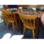 A SET OF FOUR REPRODUCTION LATH BACK KITCHEN CHAIRS, a pine kitchen table and another table