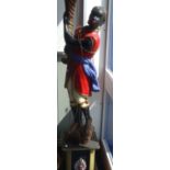 A PAIR OF BLACKAMOOR FIGURES with red jackets, wired for electricity, on plinths, 150cm high