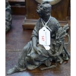 A 19TH CENTURY SPELTER STUDY OF A SEATED WOMAN and a cast iron doorstop (2)