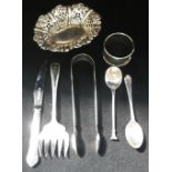 A PAIR OF GEORGE III SILVER SUGAR TONGS, a silver bon bon dish, napkin ring, two spoons, a silver