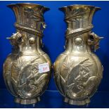 A PAIR OF CHINESE BRASS VASES entwined with dragons, 24cm high