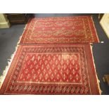 A TEKKE BOKHARA RUG, the brick red ground with two rows of octagonal "elephant's foot" guhls with-in