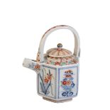 A JAPANESE KAKIEMON TEA POT, MEIJI PERIOD, the hexagonal sides painted with panels of lotus and