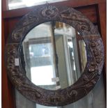 AN ART NOUVEAU EMBOSSED COPPER CIRCULAR WALL MIRROR, in the style of Pearson, 53cm dia